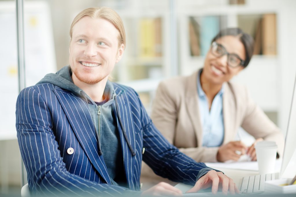 Young male entrepreneur meeting with colleagues to discuss an idea 