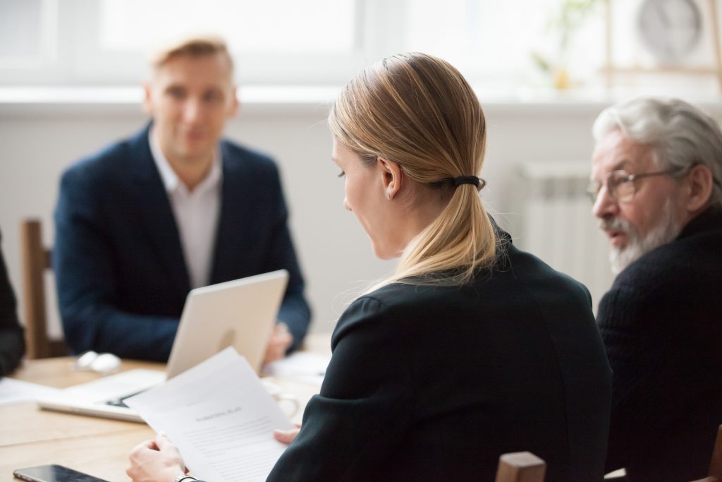 Male and female suited professional services meeting