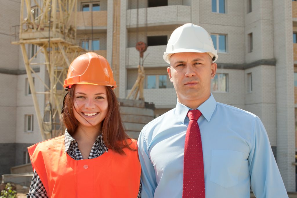 Male and female construction managers on site