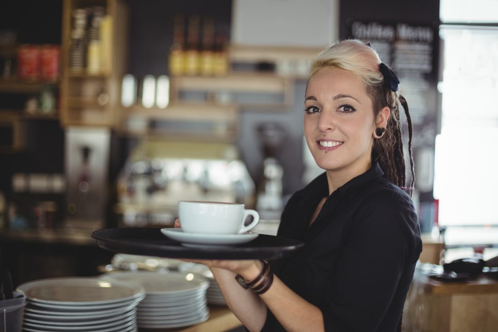 Femail coffee shop owner serving coffee